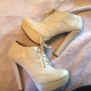 High heeled white lace ups